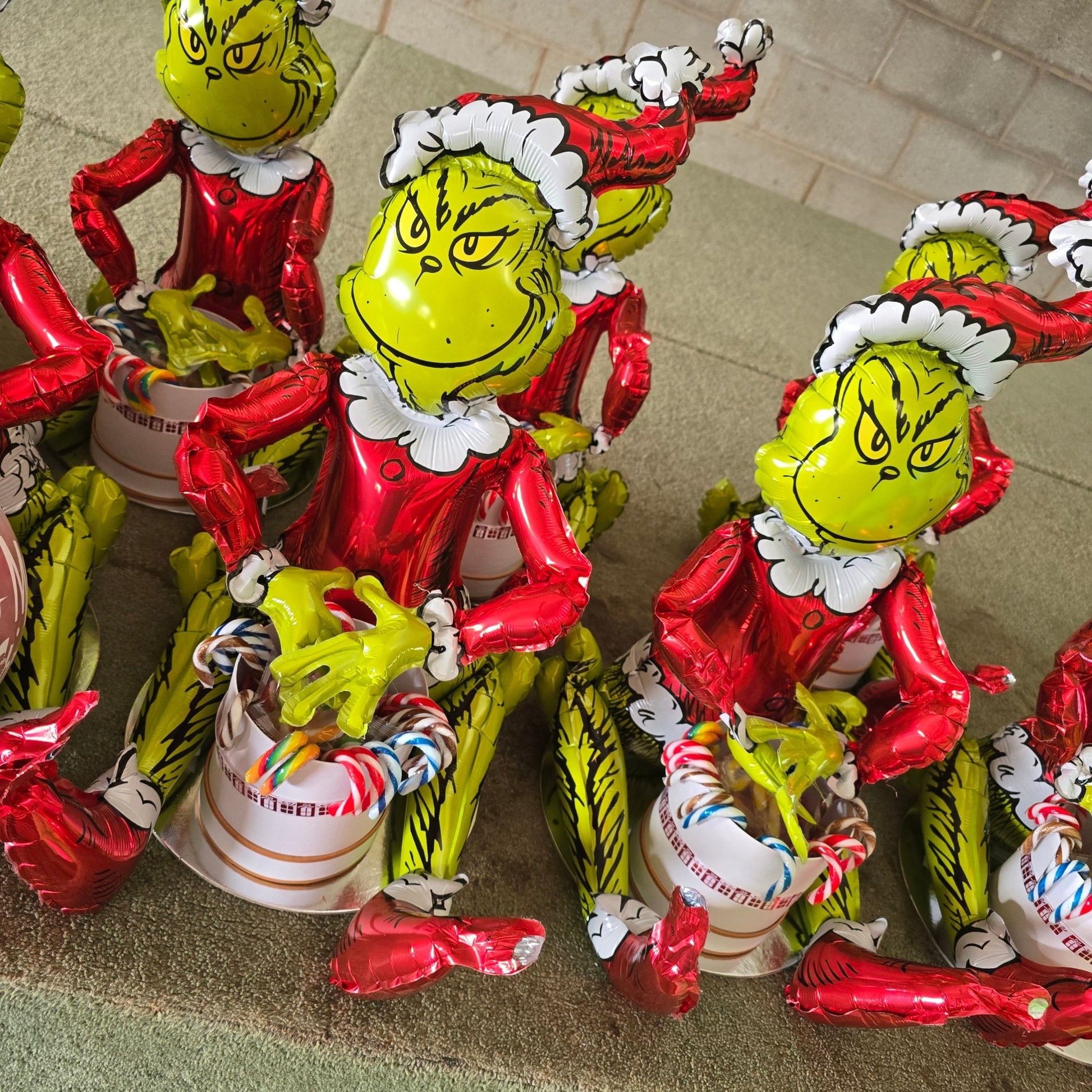 Grinch Sitting with a tiny hat box & 24 Candy Canes - UpUpNAwayBalloons