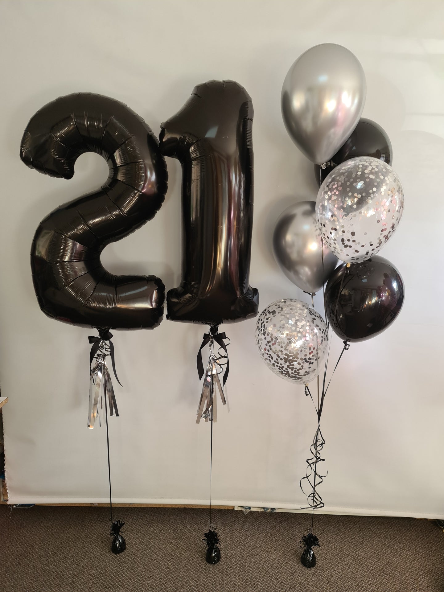 balloon numbers [double digit] with tassel, bow & accompanying bouquet.